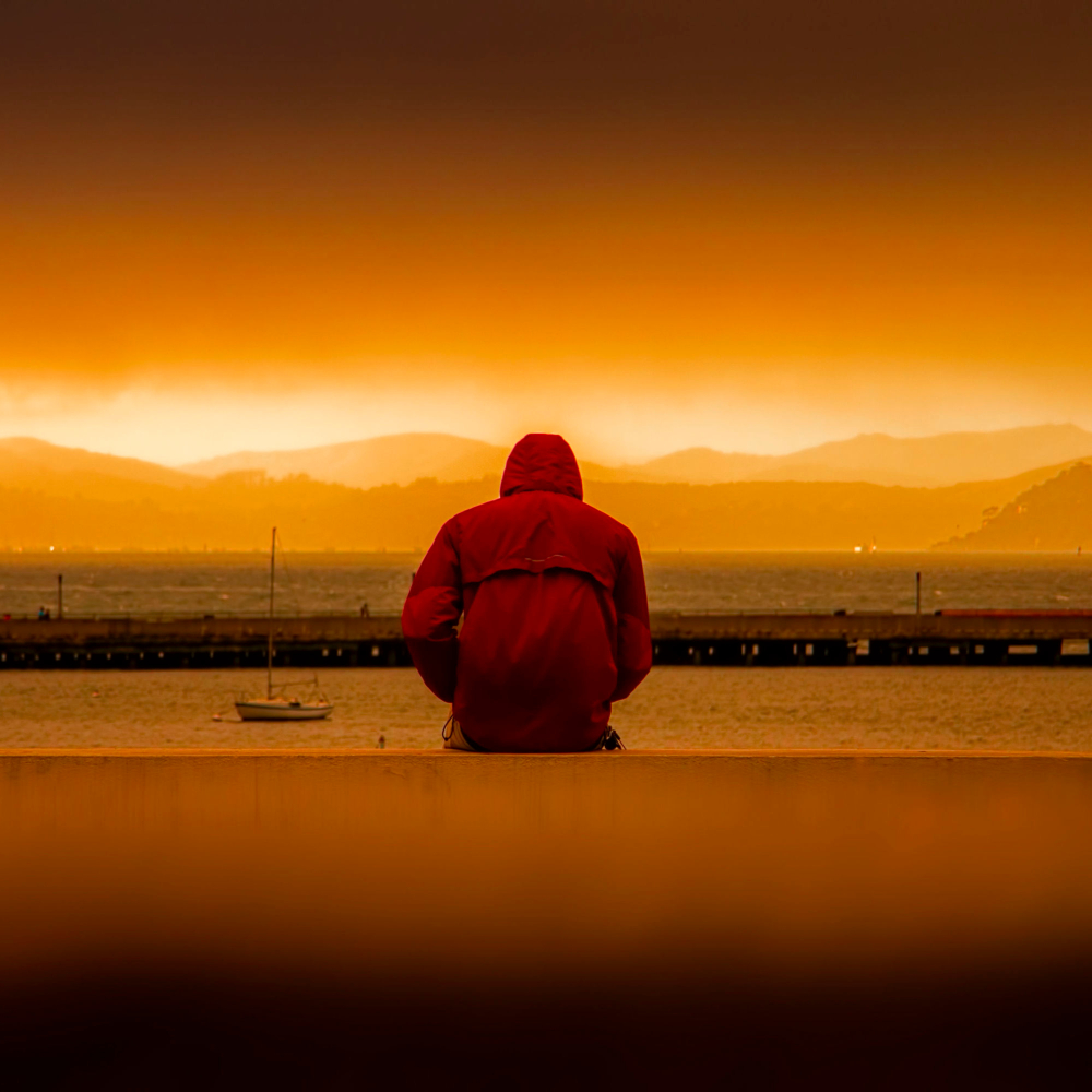 someone sat alone at sunrise