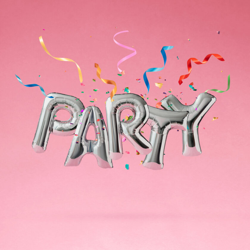 Silver foil balloons spelling PARTY float against a pink background, surrounded by colorful confetti and curling ribbons.