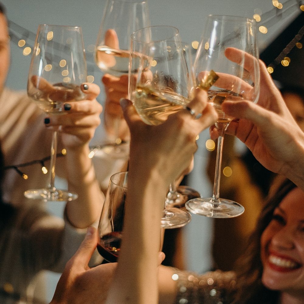 people clinking glasses at a party