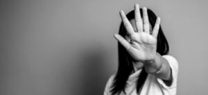 women with her hand out in black and white