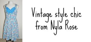 A sleeveless vintage-style dress with a blue floral pattern and blue bodice is displayed on a mannequin. Next to it, text reads Vintage style chic from Nyla Rose on a white background.