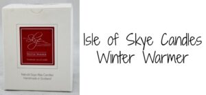 A white box with a red label for Isle of Skye Candles, Winter Warmer is on the left. The box mentions handmade natural soya wax candles from Scotland. On the right, the text Isle of Skye Candles Winter Warmer is written in black.