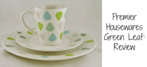 Ceramic dinner set with green and blue leaf designs, including a cup, plate, and side plate, displayed on a white background. Text on the right reads Premier Housewares Green Leaf: Review.