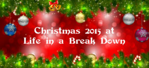 Festive Christmas banner with green garland, baubles, and candy canes framing a red background. Text reads Christmas 2015 at Life in a Break Down.