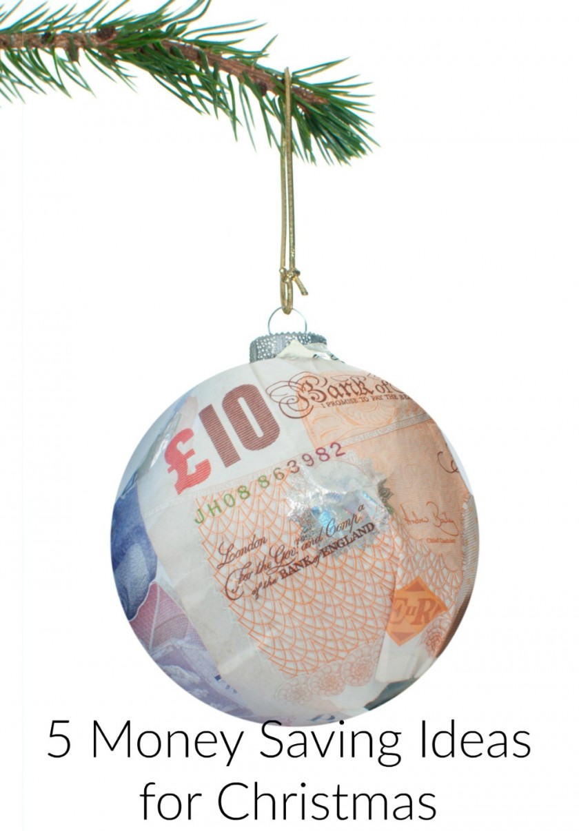 Christmas bauble made of dollar banknotes hanging from a tree