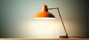 red desk lamp with wide lamp shade