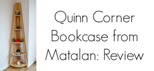 A wooden corner bookcase with five circular shelves, each holding small decorative items. On the right, text reads Quinn Corner Matalan Bookcase: Review.