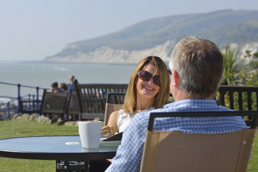 couple-sat-at-table-smiling