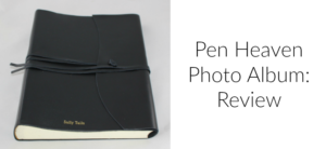 A black leather-bound photo album with the words Salty Tails embossed on the cover is on the left. On the right, text reads Pen Heaven Photo Album: Review. The album is tied with a matching leather strap.