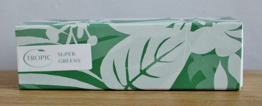 Tropic Skin Care SUPER GREENS this is a photo of the outer packing of this product the boxes uses different shades of green to make a leaf pattern and is held closed with a sticker that says Tropic SUPER GREENS