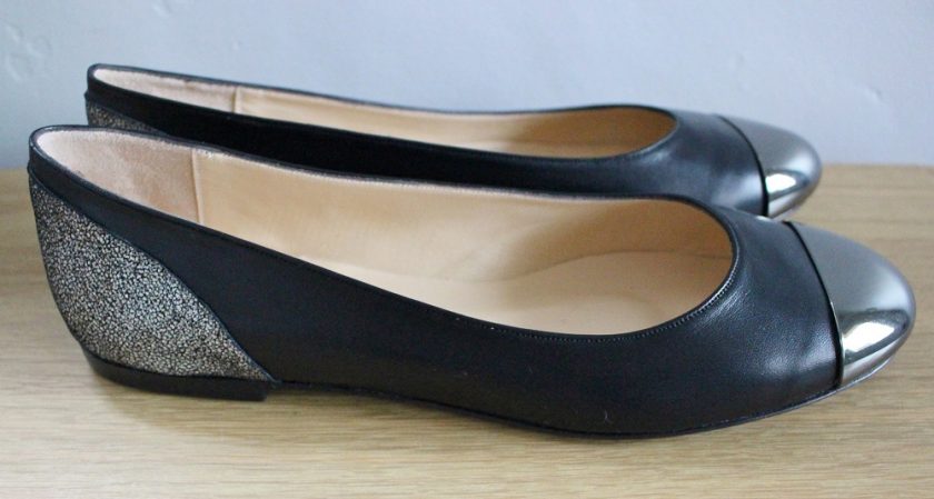 Made in Me Shoes Black Soft Leather Round Toe Ballet Shoes with Silver Leopard Fantasy Heels and Smoked Nickle Toe Plate. Picture Shoes one shoe from the side and one from the front. - View from the side..