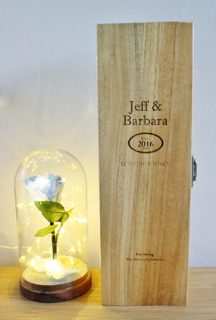 Personalised Macallan Whisky Gift Box sat next to a blue forever rose in glass dome with fairy lights.