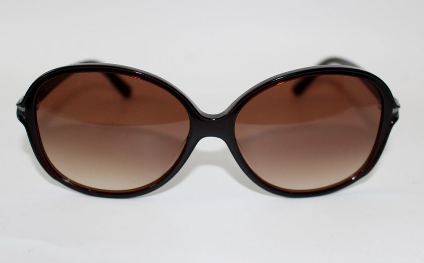 WILLIAM MORRIS ROUNDED SUNGLASSES view of glasses from the front, the arm has a gold detail to just before the glasses start, the glasses are brown in colour