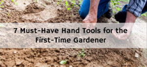 A person kneeling and digging in a garden with bare hands. The soil is brown and a few green plants are visible. Text overlay reads, 7 Must-Have Hand Tools for the First-Time Gardener.