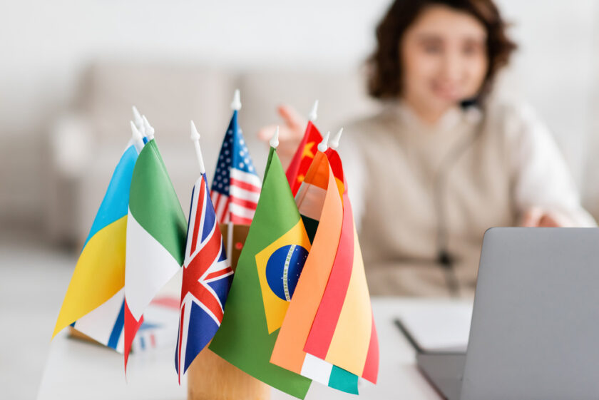 woman sat teaching with a range of flags to the side of her