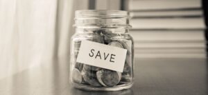 coins in a jar with the word save on it
