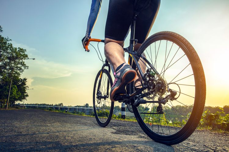 man on a bicycle - cycling along a road