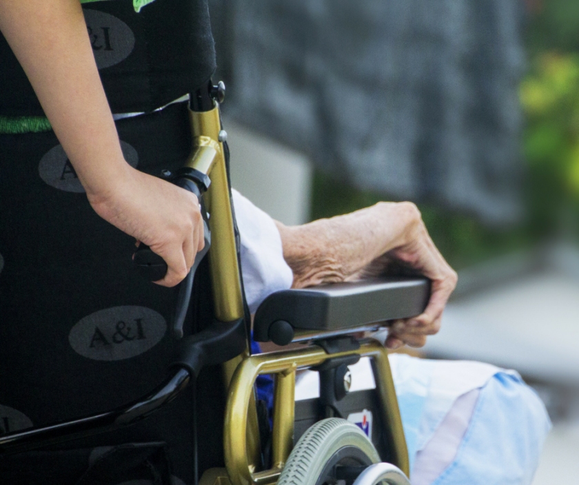 Getting Care for a Loved One - Someone being pushed in a wheelchair