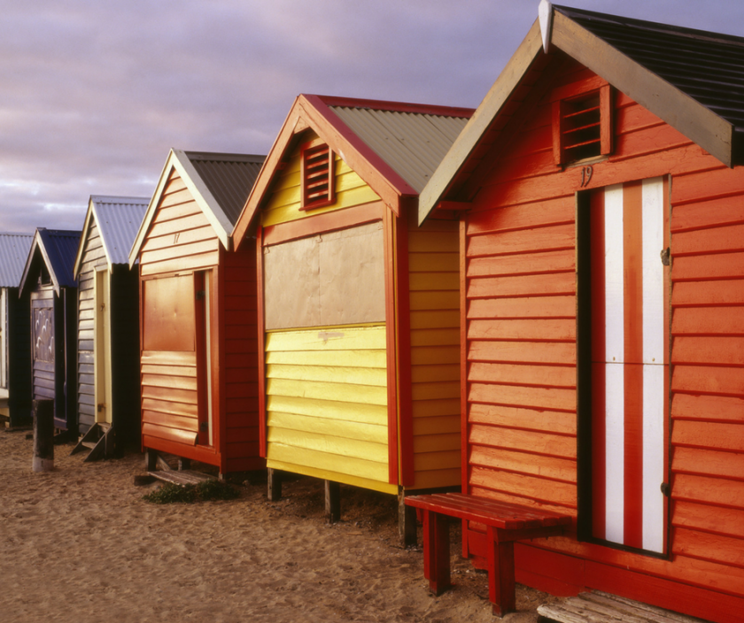 row of beach huts in different colours