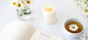 flowers candle and self care book