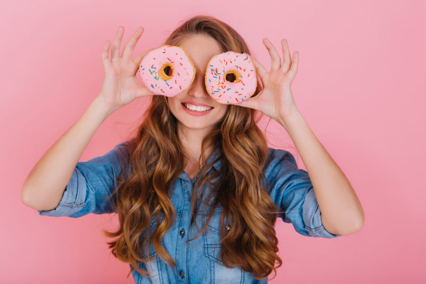 lady with doughnuts in front of her eyes