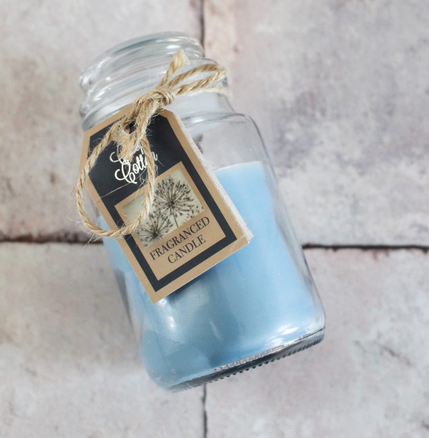 Candle from the box - the wax is blue and it's inside a glass jar with lid.