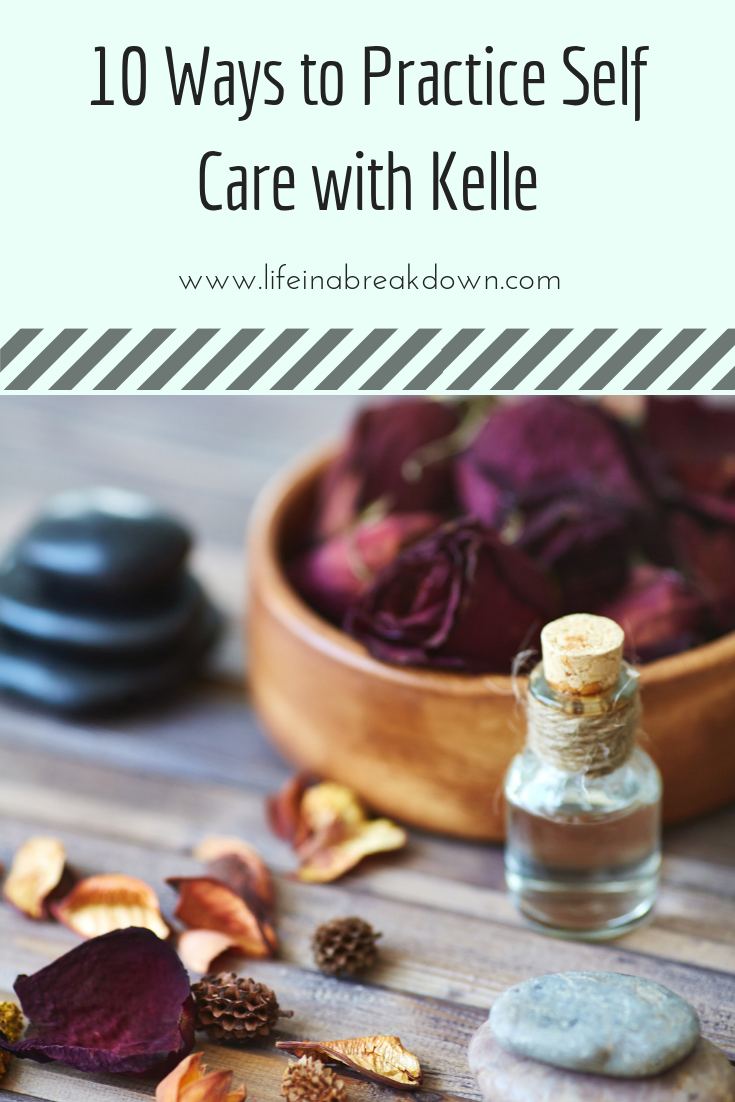A corked glass bottle with oil is placed on a wooden surface near a bowl of dried rose petals. Smooth black stones and scattered dried petals surround it. The text above reads 10 Ways to Practice Self Care with Kelle and the URL www.lifeinabreakdown.com.