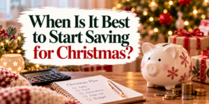 Text reads When Is It Best to Start Saving for Christmas? displayed over a desk with a piggy bank, a calculator, and a written holiday plan.