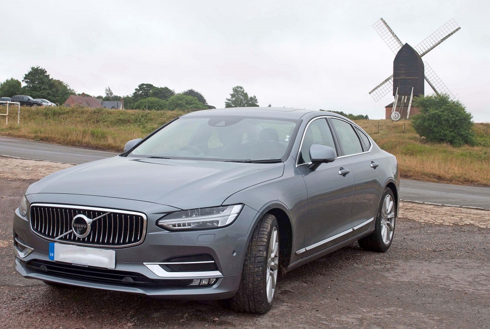Volvo S90 pictured in front of a windmill
