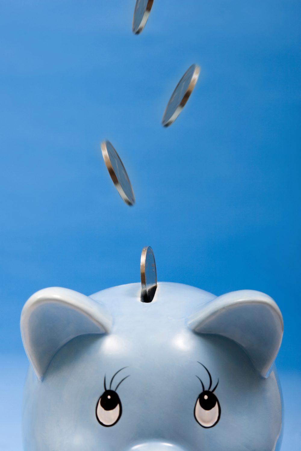 Pennies Falling into a Piggy Bank