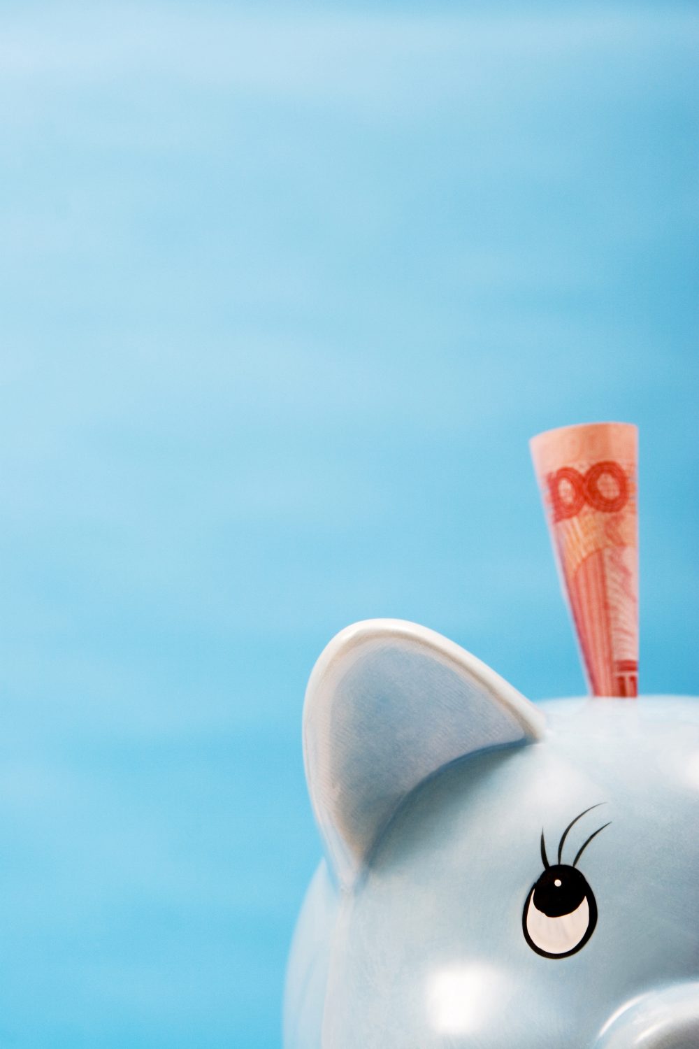Light Blue Piggy Bank with a Note Coming Out of It