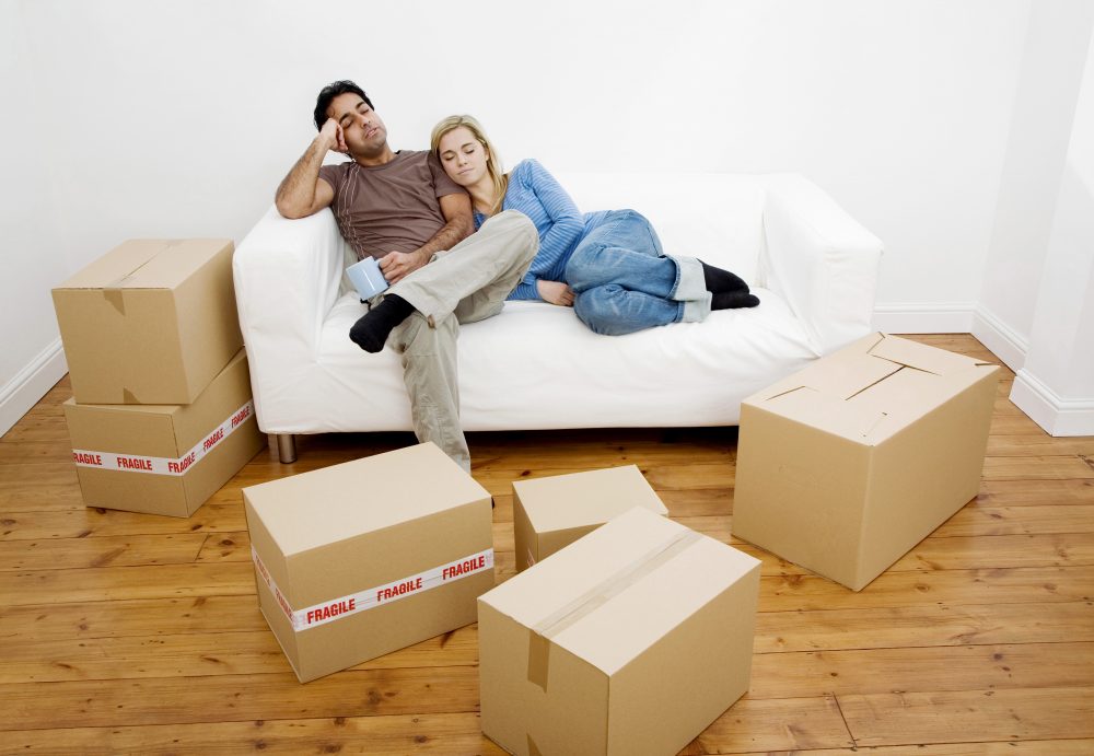 Couple on sofa surrounded by boxes