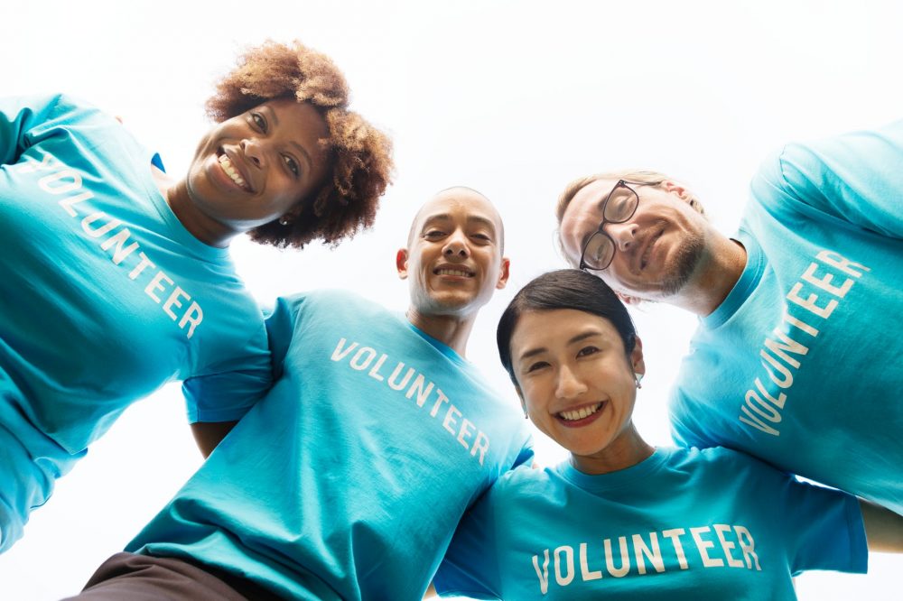 A Group of people with volunteer on their tops