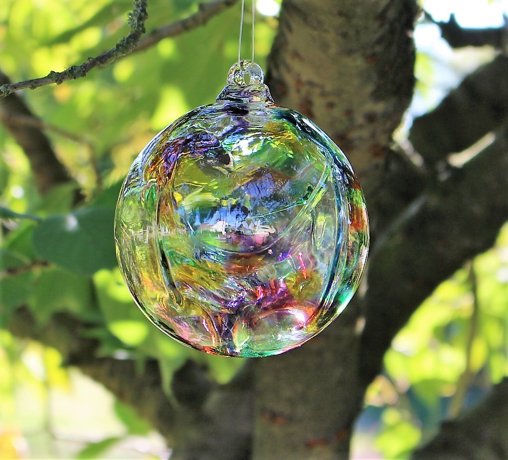 Rainbow Glass Witch Ball from Peach Perfect Hanging in a Tree