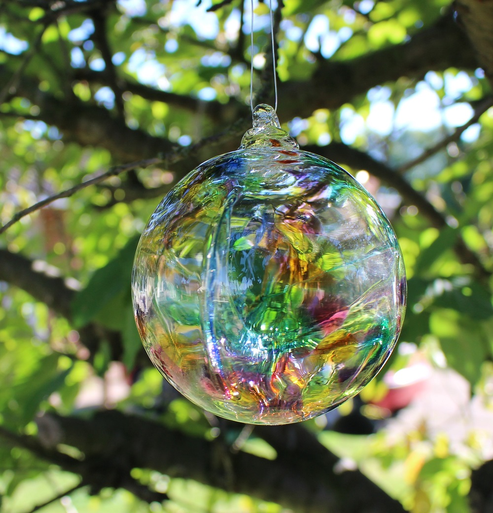 Rainbow Glass Witch Ball from Peach Perfect Hanging in a Tree
