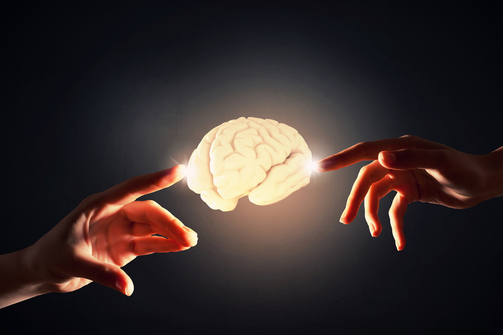Close up of human hand touching with finger human brain