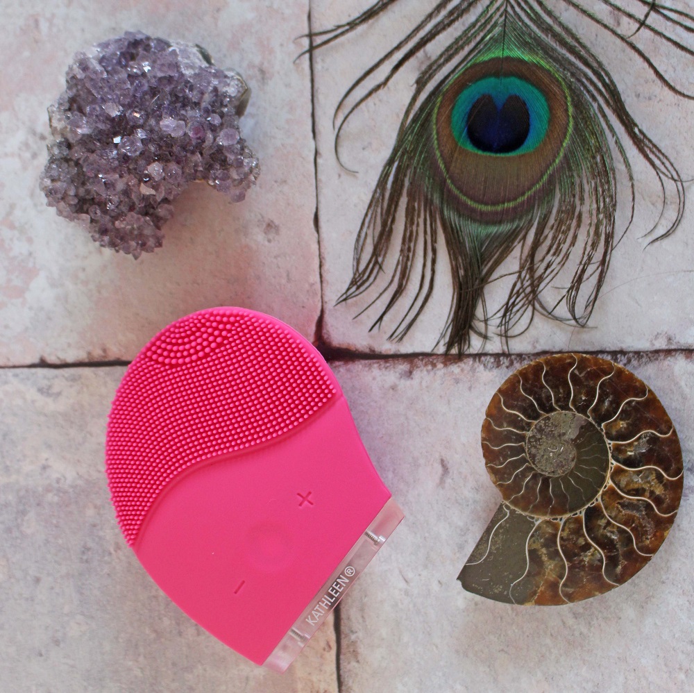 Kathleen Facial Sonic Cleansing Device - it is a pink device with stippling one end and a part to hold it the other