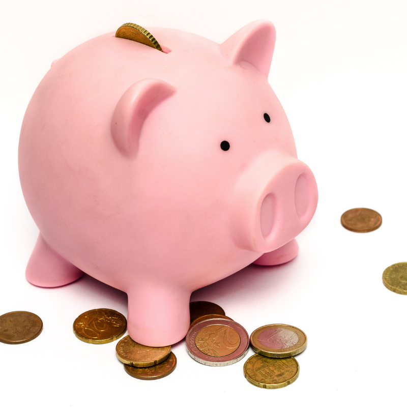 Piggy bank on top of coins