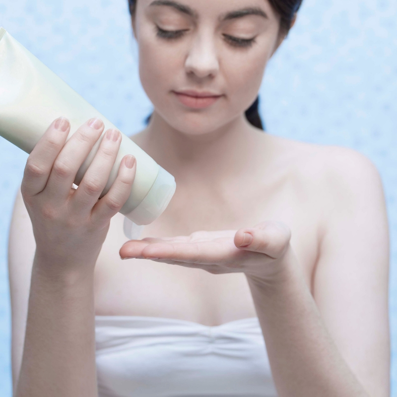 lady applying cream to her hands