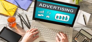 person on a laptop with advertising on the screen