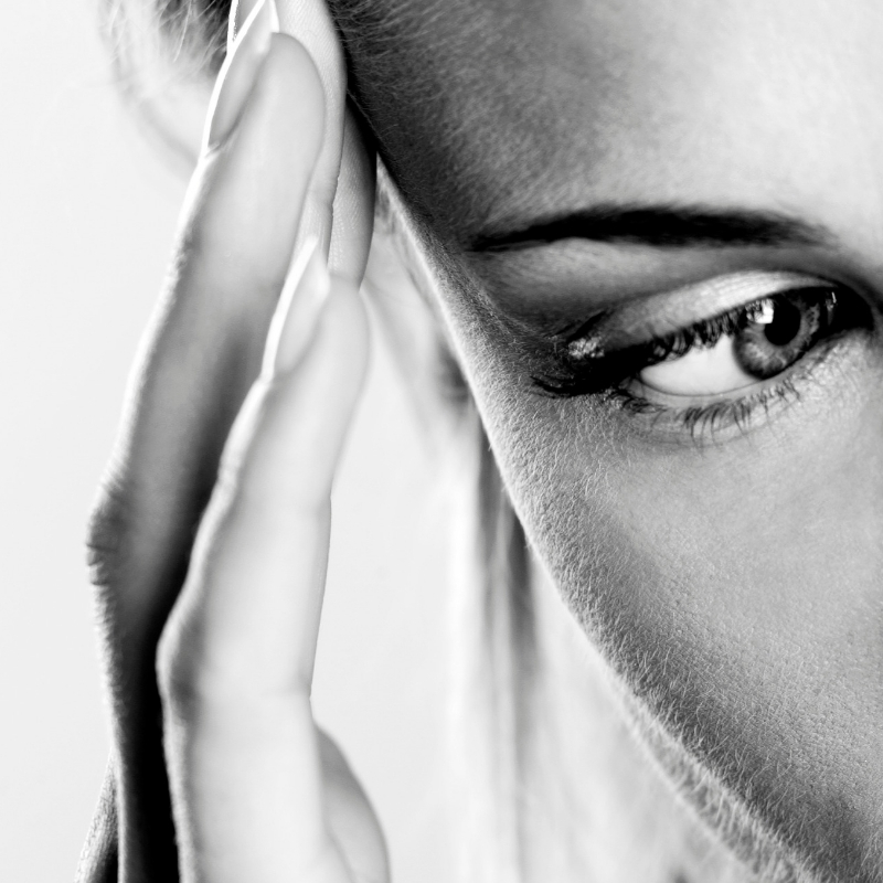 women in black and white with hand to head