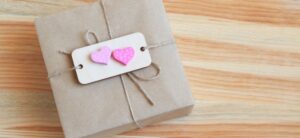 box tied with twine and 2 hearts on it