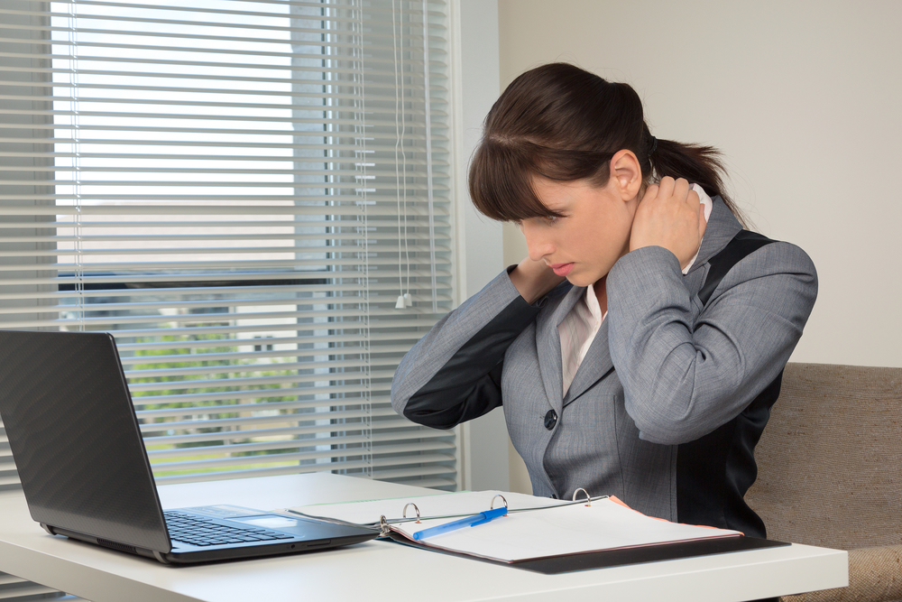 The image of business woman doing exercise at the office