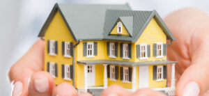 picture of someone holding a house in their hands