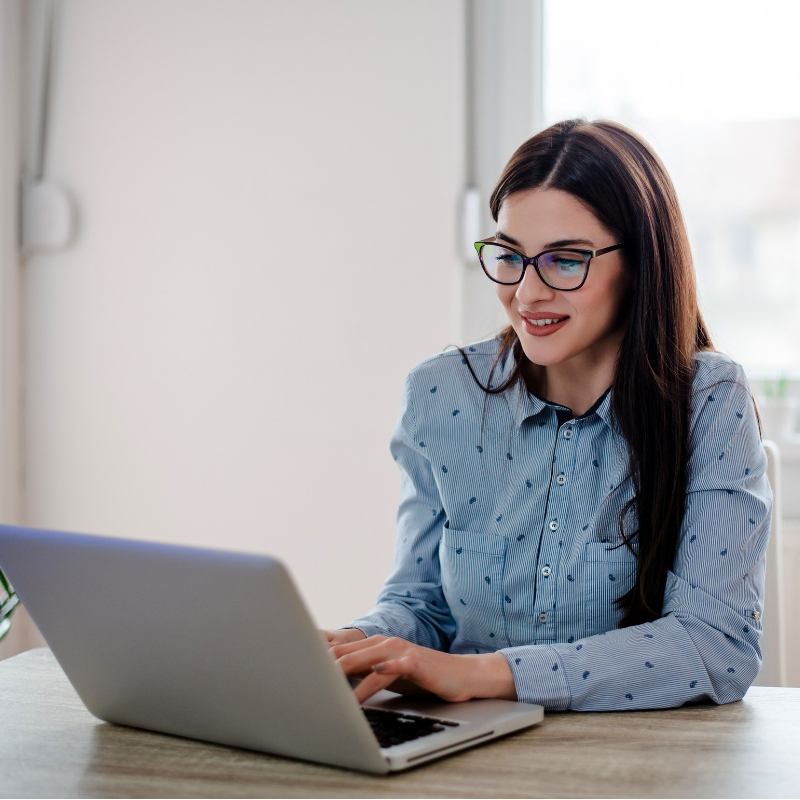 women sat working at her laptop
