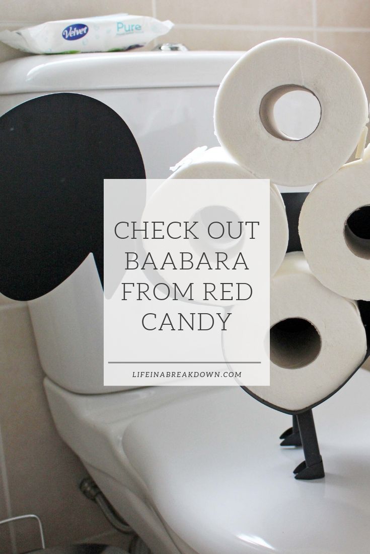 A stack of toilet paper rolls arranged to resemble a sheep on a bathroom toilet, complete with a speech bubble and the playful text, Check out Baabara from Red Candy.