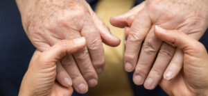 person holding an older persons hand
