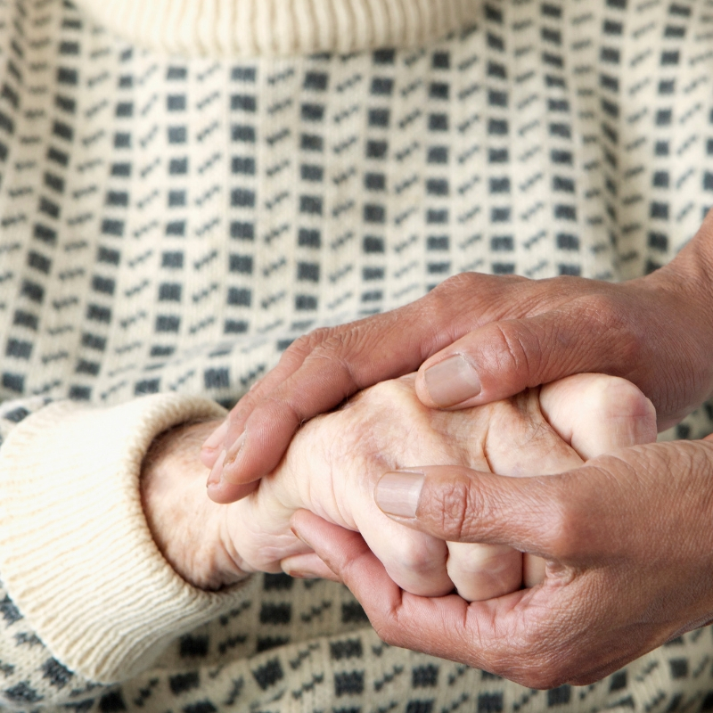 person with their hands round an older persons