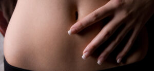 picture of a women with her hand on her stomach