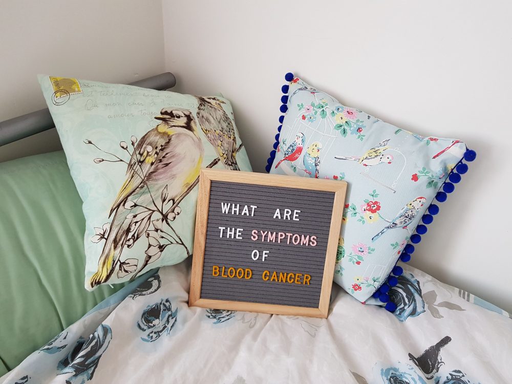 Pin board laying on cushions reading what are the symptoms of blood cancer